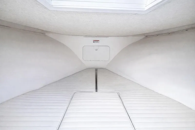 Slide: The Image of Interior cabin of 2017 Dusky 252 boat with white cushioned seating. - 15