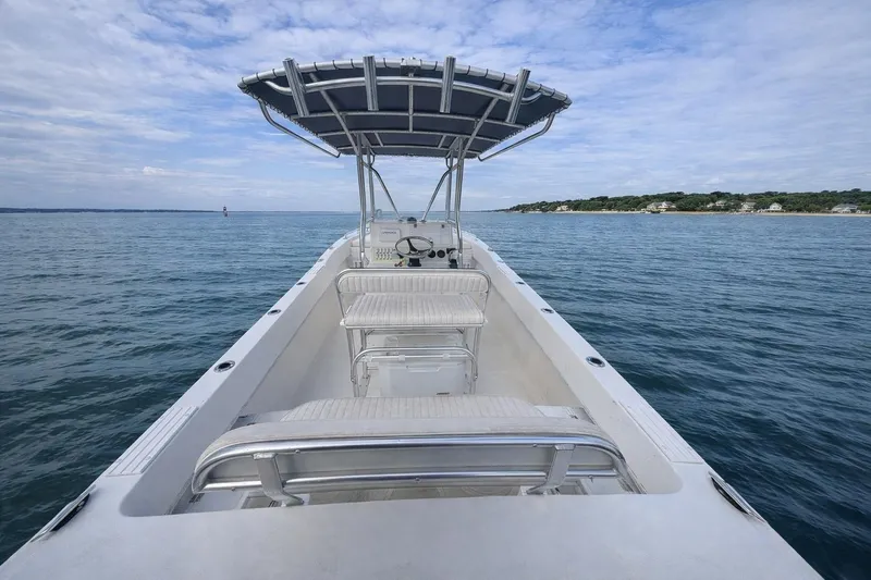 Slide: The Image of 2017 Dusky 252 boat on calm ocean with clear sky and distant shoreline. - 3
