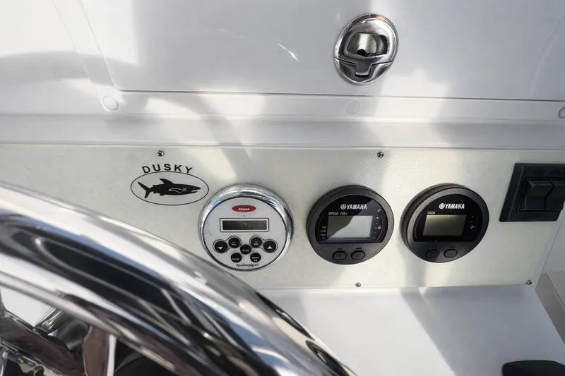 Slide: The Image of Dashboard of 2017 Dusky 252 boat with Yamaha gauges and controls. - 11