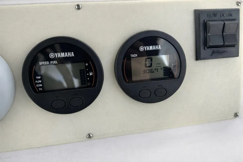 Slide: The Image of Yamaha speed and tachometer gauges on a 2017 Dusky 252 boat dashboard. - 12