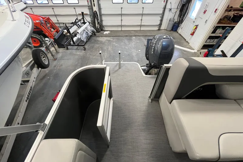Slide: The Image of 2026 Godfrey Sweetwater 2086 CP pontoon boat interior in a garage setting. - 11