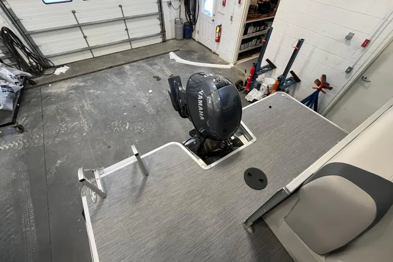 Slide: The Image of 2026 Godfrey Sweetwater 2086 CP boat with Yamaha outboard motor in a garage setting. - 12