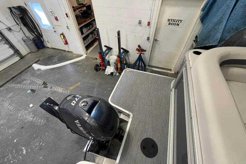 Slide: The Image of 2026 Godfrey Sweetwater 2086 CP boat in garage with Yamaha outboard motor. - 13