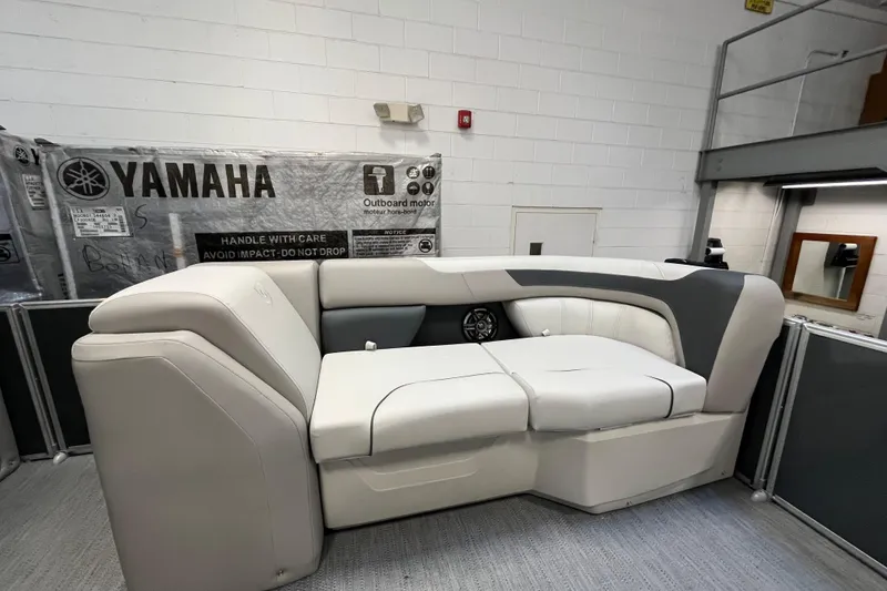 Slide: The Image of 2026 Godfrey Sweetwater 2086 CP boat seating in a showroom with Yamaha packaging. - 15