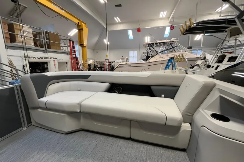 Slide: The Image of 2026 Godfrey Sweetwater 2086 CP boat interior with plush seating in a service center. - 19