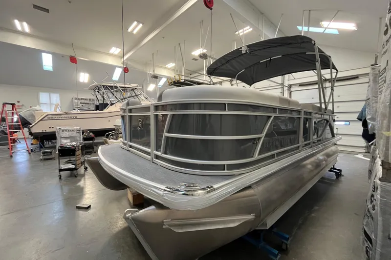 Slide: The Image of 2026 Godfrey Sweetwater 2086 CP pontoon boat in indoor storage facility. - 2