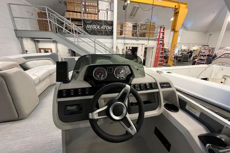 Slide: The Image of Interior view of 2026 Godfrey Sweetwater 2086 CP boat, showcasing steering console and seating. - 21