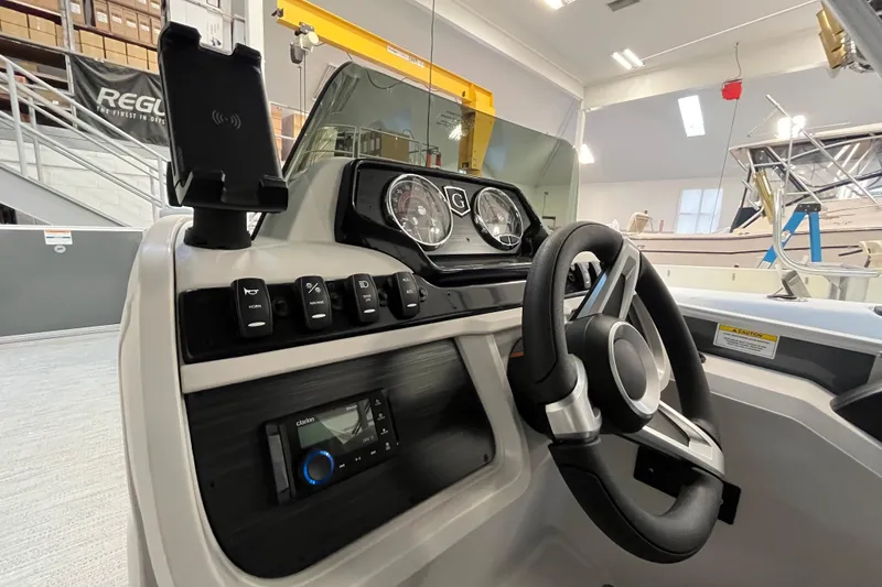 Slide: The Image of 2026 Godfrey Sweetwater 2086 CP boat dashboard with steering wheel and control panel. - 22