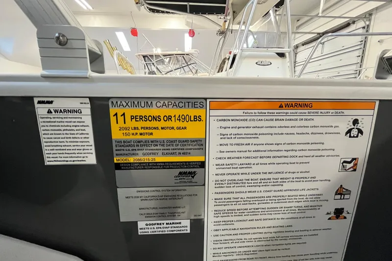 Slide: The Image of Safety and capacity labels on a 2026 Godfrey Sweetwater 2086 CP boat. - 23