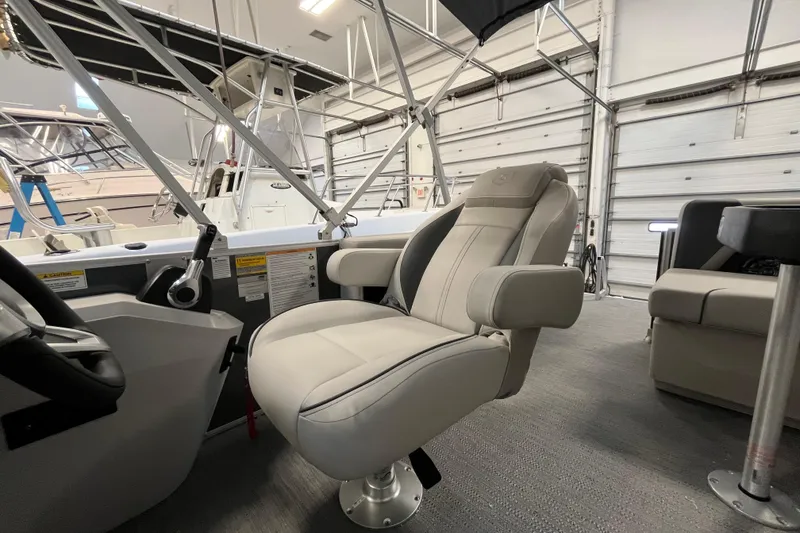 Slide: The Image of 2026 Godfrey Sweetwater 2086 CP boat interior with plush captain's chair. - 25