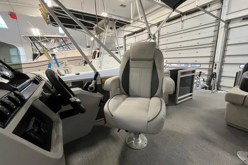 Slide: The Image of Interior of 2026 Godfrey Sweetwater 2086 CP boat with captain's chair and control panel. - 26