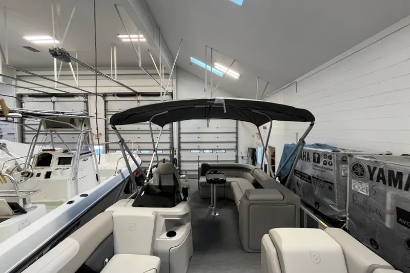 Slide: The Image of 2026 Godfrey Sweetwater 2086 CP pontoon boat in indoor storage facility. - 27