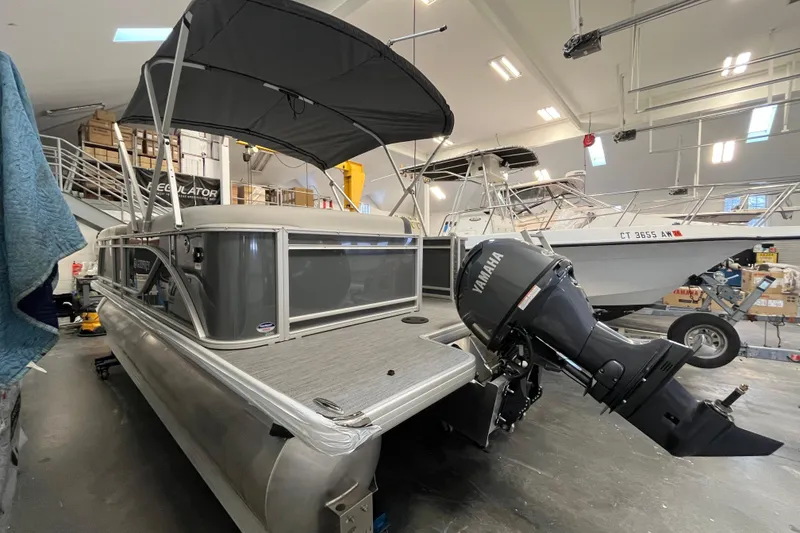Slide: The Image of 2026 Godfrey Sweetwater 2086 CP pontoon boat with Yamaha outboard motor in a showroom. - 3