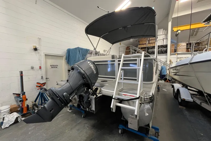 Slide: The Image of 2026 Godfrey Sweetwater 2086 CP pontoon boat with Yamaha outboard in a workshop. - 4