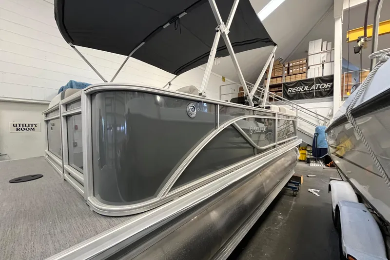 Slide: The Image of 2026 Godfrey Sweetwater 2086 CP pontoon boat in showroom, featuring sleek design and canopy. - 5