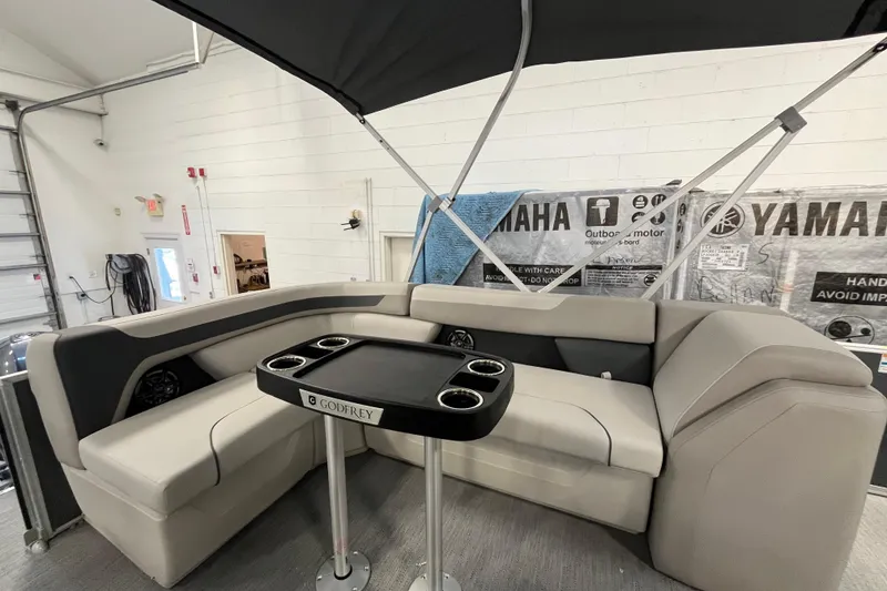 Slide: The Image of 2026 Godfrey Sweetwater 2086 CP boat interior with seating and table. - 7