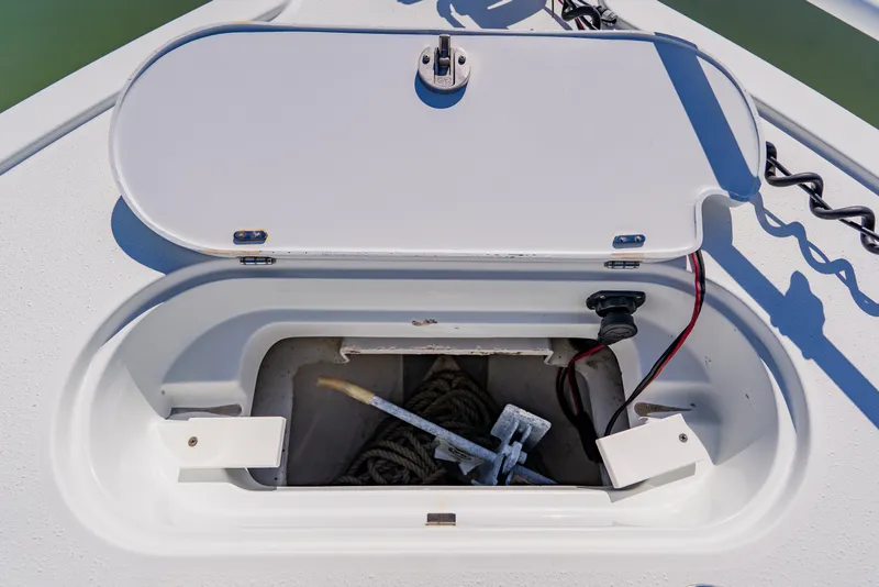 Slide: The Image of 2015 Yellowfin 39 Offshore anchor compartment with open hatch and visible rope. - 13