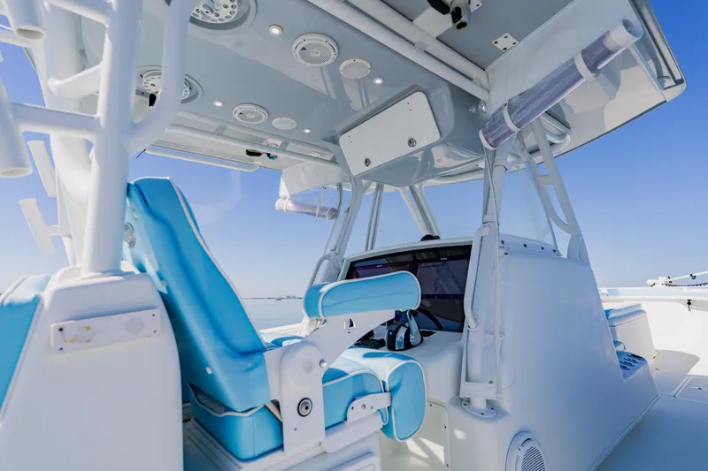 Slide: The Image of 2015 Yellowfin 39 Offshore boat interior with blue seating and modern controls. - 18