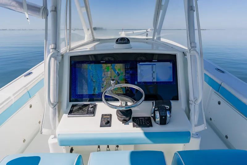 Slide: The Image of 2015 Yellowfin 39 Offshore boat dashboard with navigation system on calm water. - 19