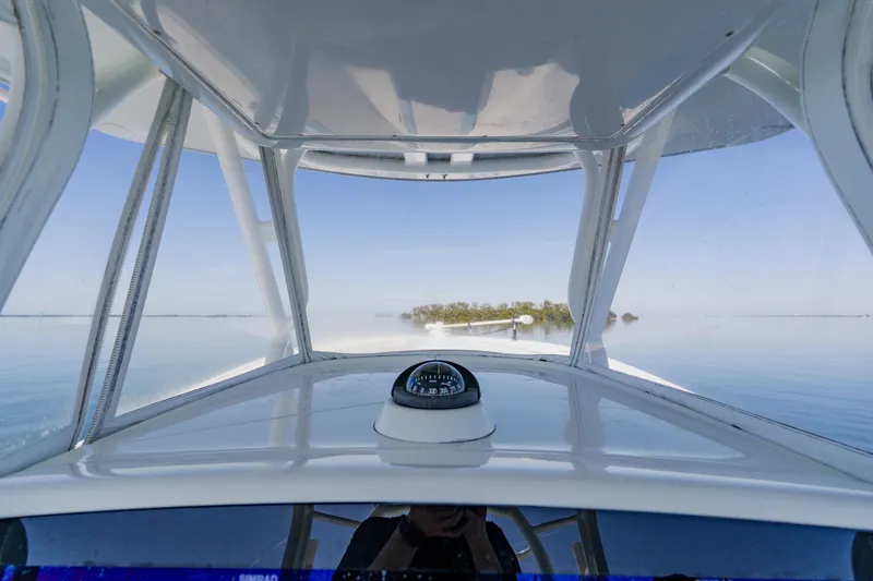 Slide: The Image of 2015 Yellowfin 39 Offshore boat navigating calm waters with island view. - 20