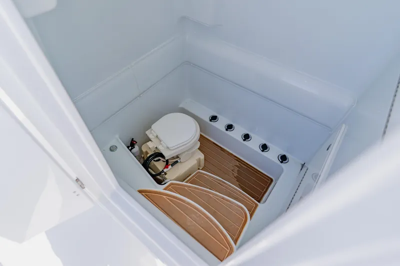 Slide: The Image of 2015 Yellowfin 39 Offshore boat interior with compact marine toilet. - 27