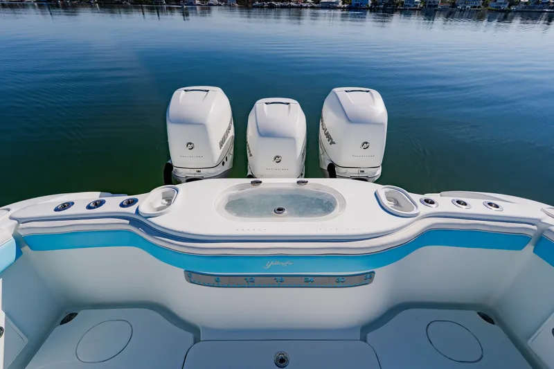 Slide: The Image of 2015 Yellowfin 39 Offshore boat with triple Mercury outboard engines on calm water. - 32