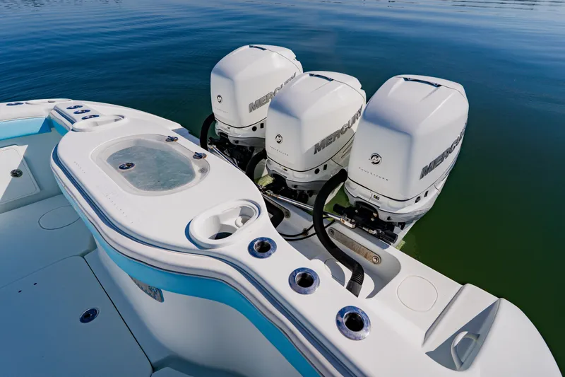 Slide: The Image of 2015 Yellowfin 39 Offshore boat with triple Mercury outboard engines on calm water. - 33