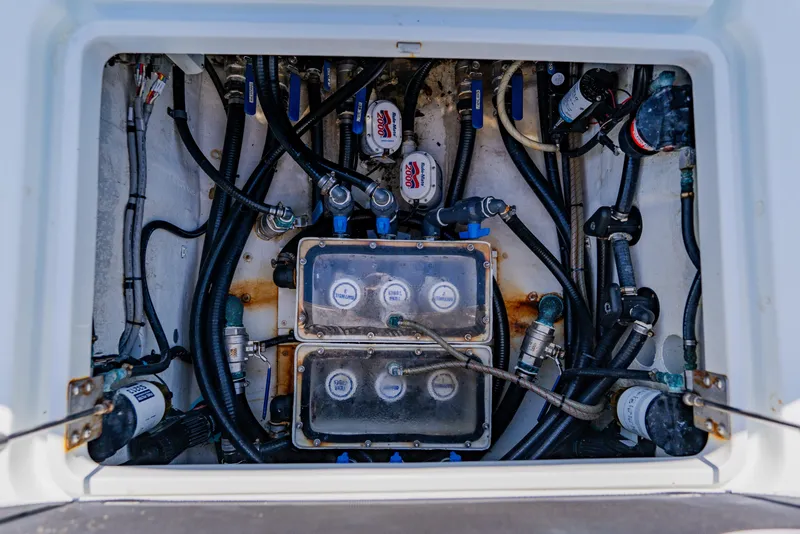 Slide: The Image of 2015 Yellowfin 39 Offshore boat engine compartment with hoses and gauges. - 35