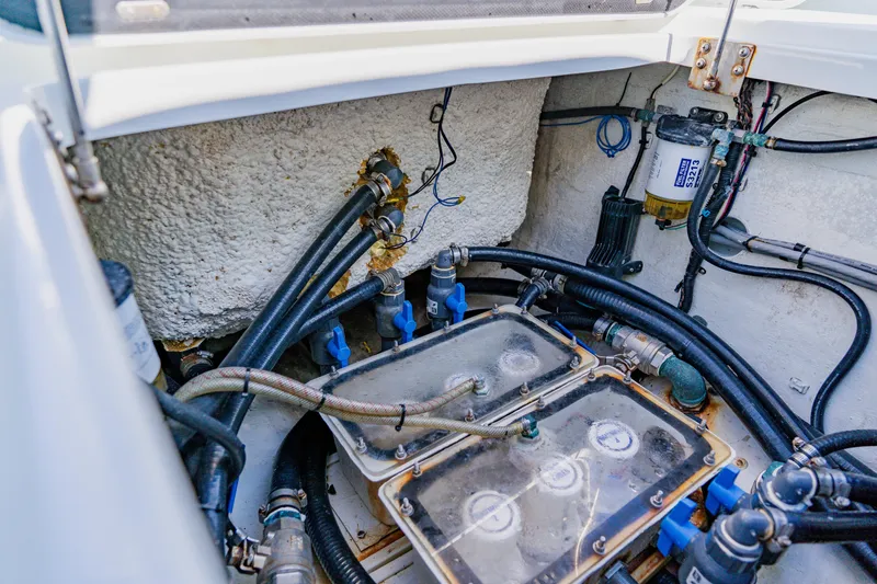 Slide: The Image of Engine compartment of a 2015 Yellowfin 39 Offshore boat, showcasing hoses and filters. - 36