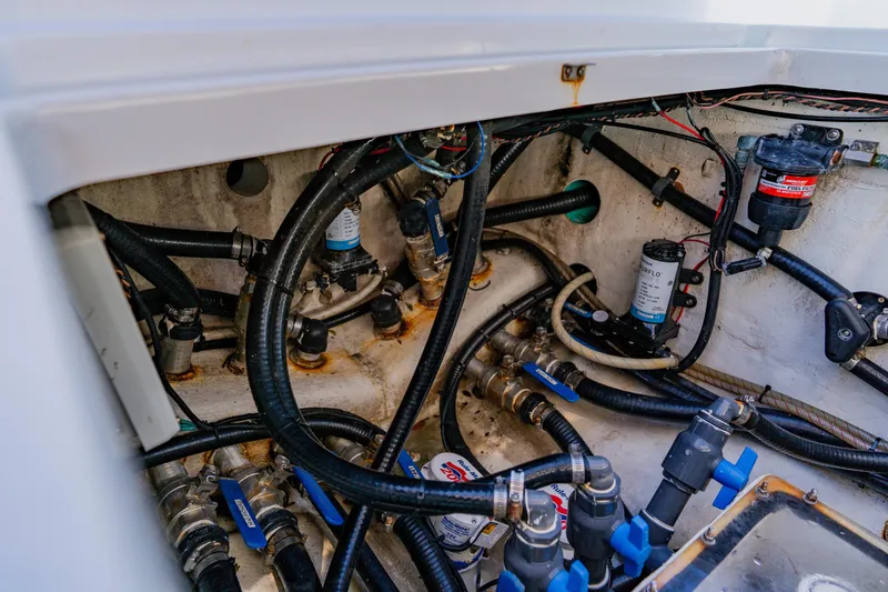 Slide: The Image of 2015 Yellowfin 39 Offshore boat engine compartment with hoses and fuel filters. - 37