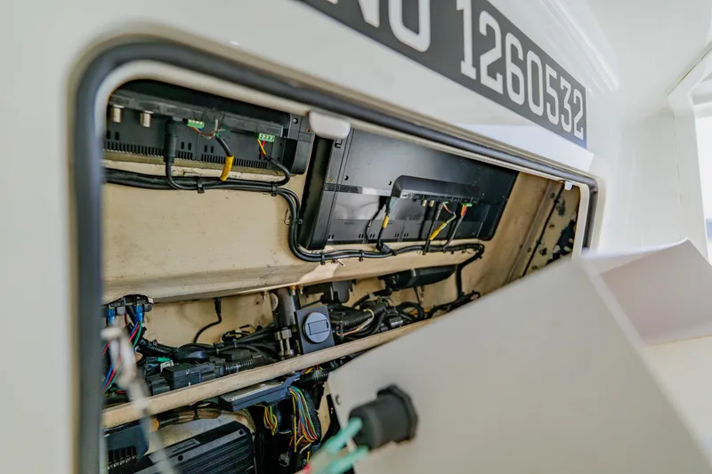 Slide: The Image of 2015 Yellowfin 39 Offshore boat electrical compartment with wiring and components visible. - 38