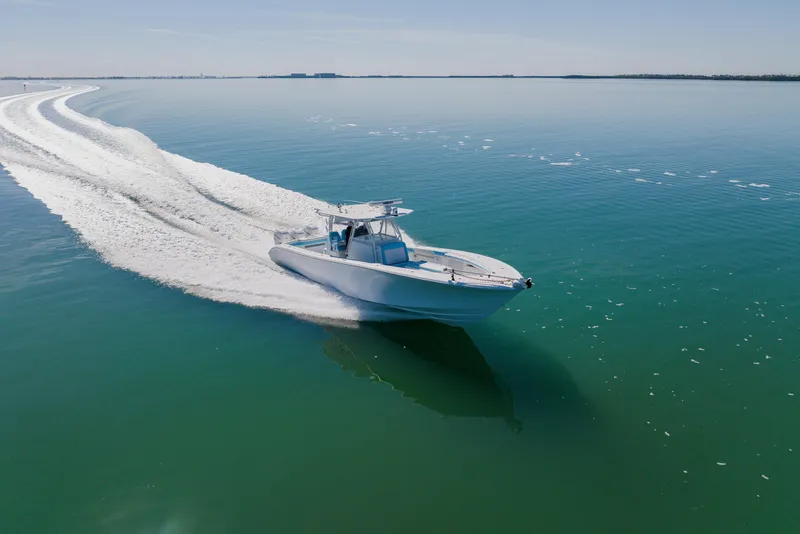 Slide: The Image of 2015 Yellowfin 39 Offshore boat cruising on calm, clear waters. - 4