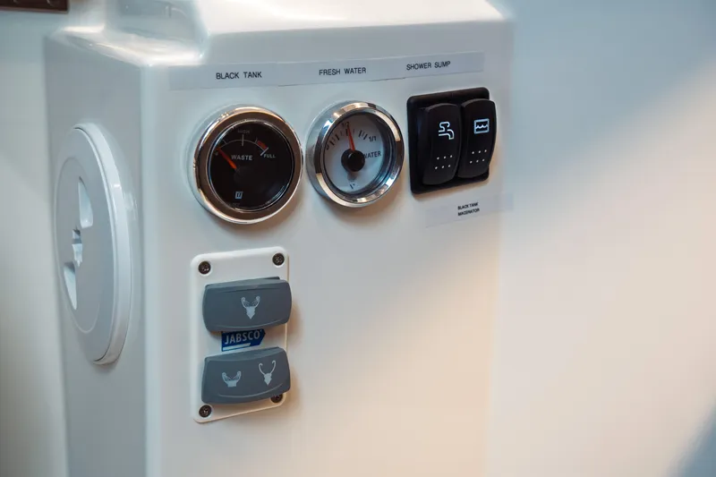 Slide: The Image of Control panel of 2025 Jeanneau NC 895 Series 2 boat, featuring gauges and switches. - 33
