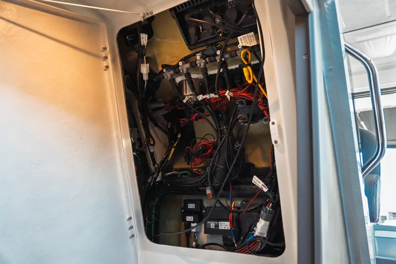 Slide: The Image of Electrical wiring inside 2025 Jeanneau NC 895 Series 2 boat, showcasing intricate connections. - 35