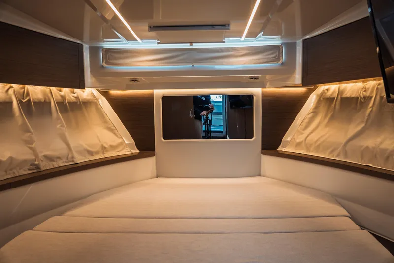 Slide: The Image of Interior cabin of 2025 Jeanneau NC 895 Series 2, featuring cozy bedding and ambient lighting. - 37