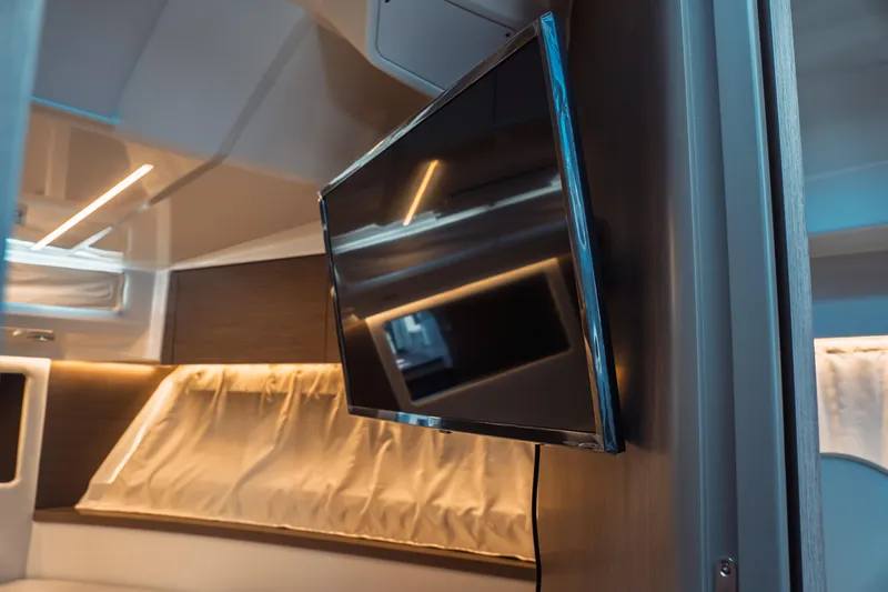Slide: The Image of Interior of 2025 Jeanneau NC 895 Series 2 with mounted TV and modern lighting. - 39