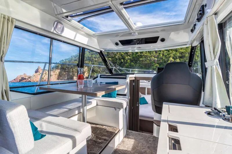 Slide: The Image of Manufacturer Provided Image: Interior of 2025 Jeanneau NC 895 Series 2 boat with panoramic windows and modern seating. - 5