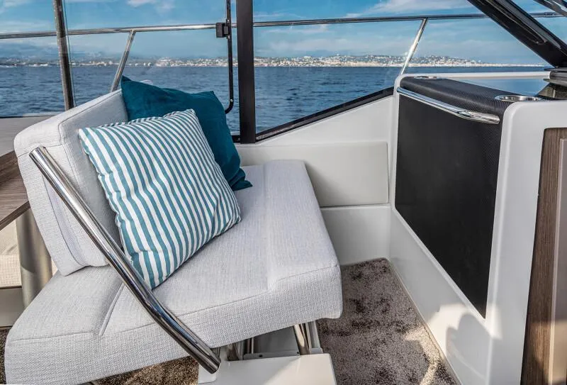 Slide: The Image of Manufacturer Provided Image: 2025 Jeanneau NC 895 Series 2 interior with cushioned seating and ocean view. - 7