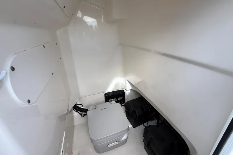 Slide: The Image of Interior of 2024 Boston Whaler 210 Montauk boat, featuring storage and equipment space. - 16