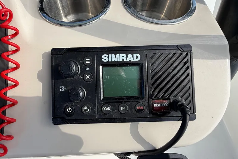 Slide: The Image of Simrad marine radio on 2024 Boston Whaler 210 Montauk boat dashboard. - 24