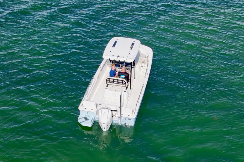 Slide: The Image of 2024 Boston Whaler 210 Montauk boat on clear green water, aerial view. - 3