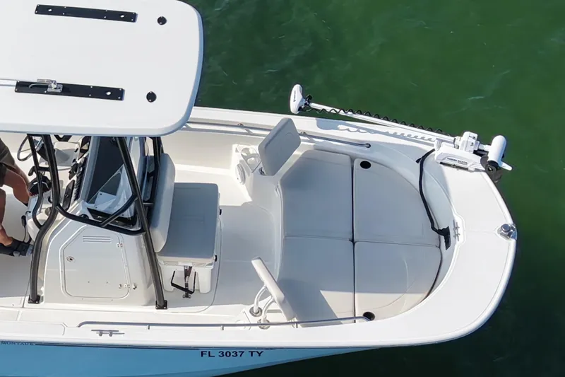Slide: The Image of 2024 Boston Whaler 210 Montauk boat, aerial view, white interior, on green water. - 4