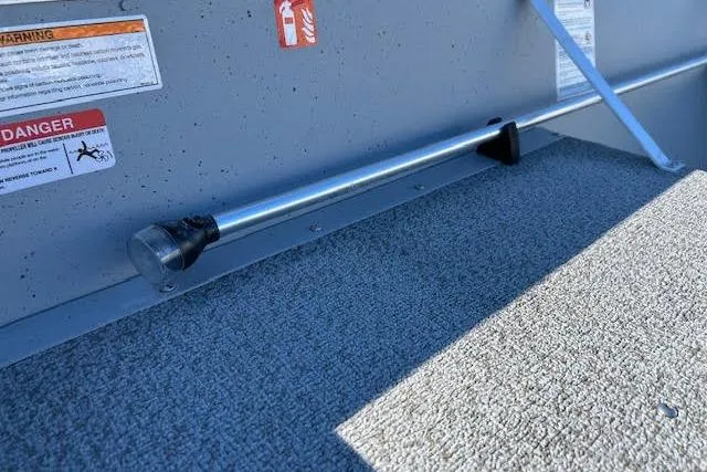 Slide: The Image of Interior view of 2026 Lund SSV-16 boat with safety warnings and carpeted floor. - 10