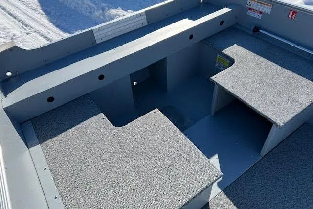 Slide: The Image of Interior of 2026 Lund SSV-16 boat with gray carpeted seating and storage compartments. - 6