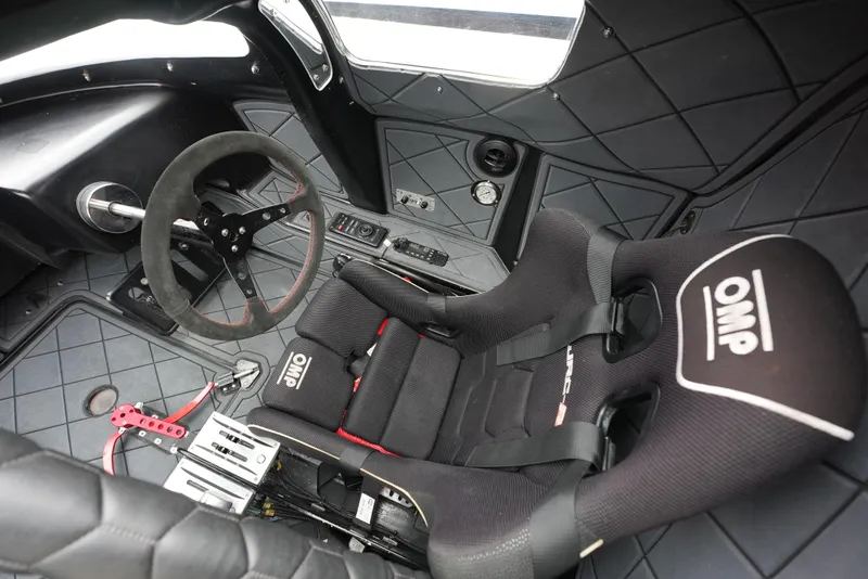 Slide: The Image of Interior of a 2019 Doug Wright 32 boat with OMP racing seat and steering wheel. - 15