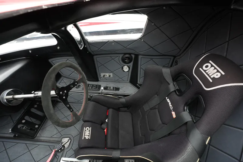 Slide: The Image of Interior of a 2019 Doug Wright 32 boat, featuring OMP racing seat and steering wheel. - 23