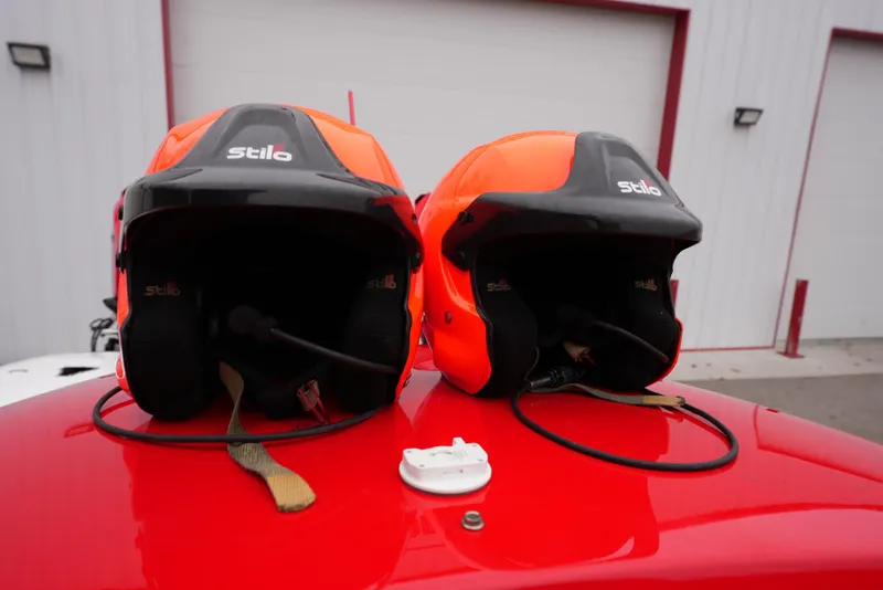 Slide: The Image of Two Stilo racing helmets on a red Doug Wright 32, 2019 model. - 7