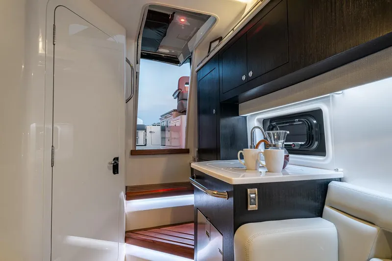 Slide: The Image of Manufacturer Provided Image: Interior of 2026 Boston Whaler 380 Realm, featuring modern kitchenette and seating area. - 11
