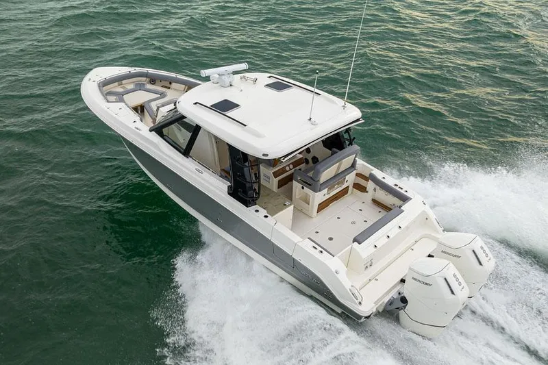 Slide: The Image of Manufacturer Provided Image: 2026 Boston Whaler 380 Realm cruising on open water, showcasing sleek design and powerful engines. - 2