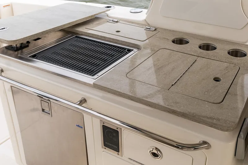 Slide: The Image of Manufacturer Provided Image: Outdoor kitchen on 2026 Boston Whaler 380 Realm boat with grill and storage. - 7